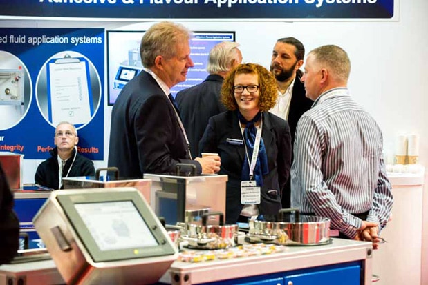 Exhibitors discuss the latest products during TABEXPO